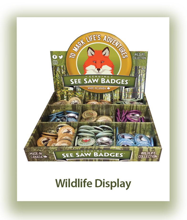 Display of colorful wildlife-themed sew saw badges in packaging.